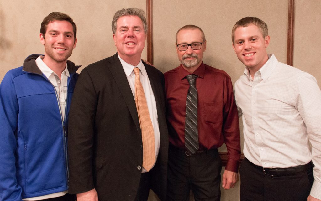 Chuck VandenLangenberg (third from left) shared memories with members of the Martin family (L-R: Joe, Edward and David) at his retirement party in May 2017.