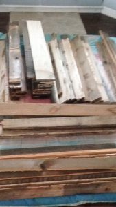 Stack of stained pallet wood, organized by size.