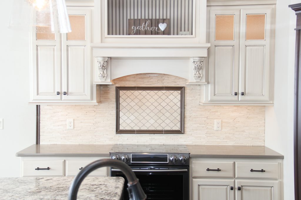 Ivory tile kitchen backsplash, accent stove tile, 2018 showcase of homes, H.J. Martin and Son