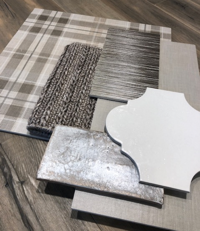 Gray and white tile and gray crochet carpet samples in a mood board.