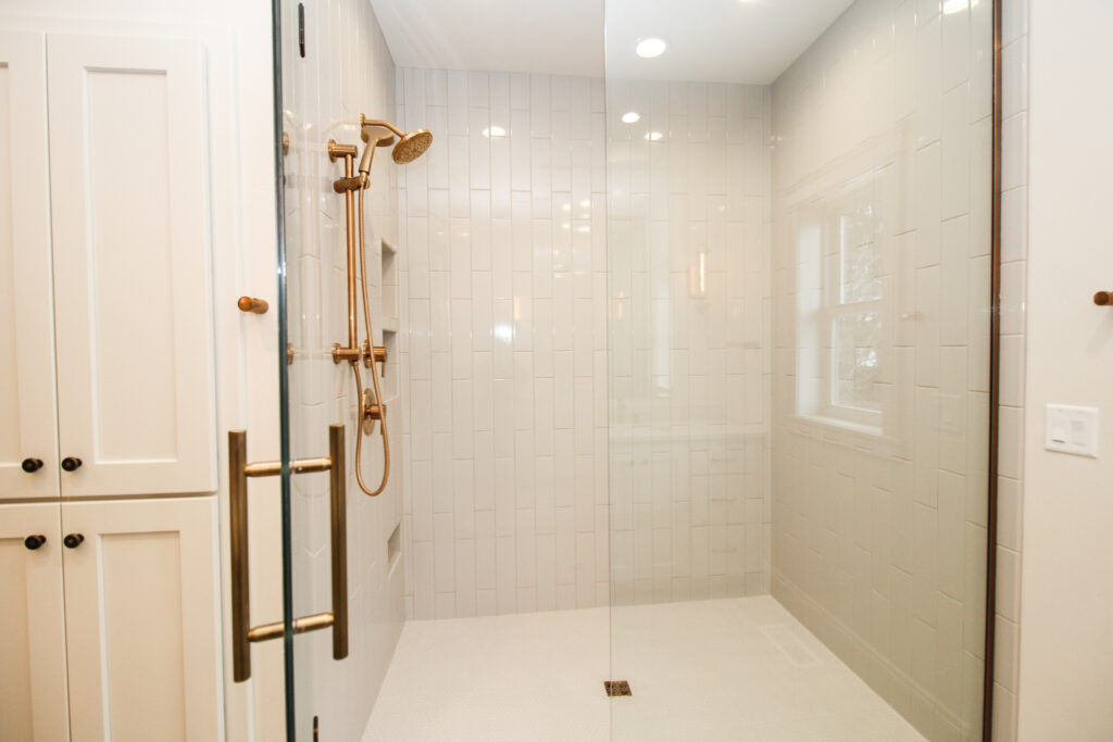 Master Bath Shower with Tiled Flooring and Glass Shower Door