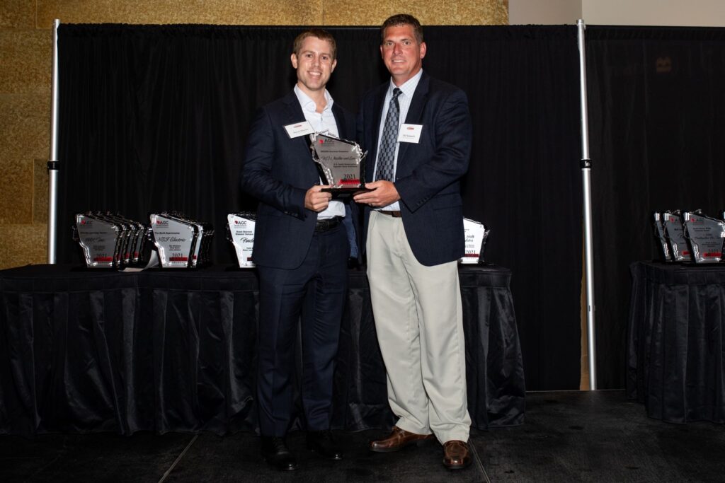 Two people hold AGC Build Wisconsin Award